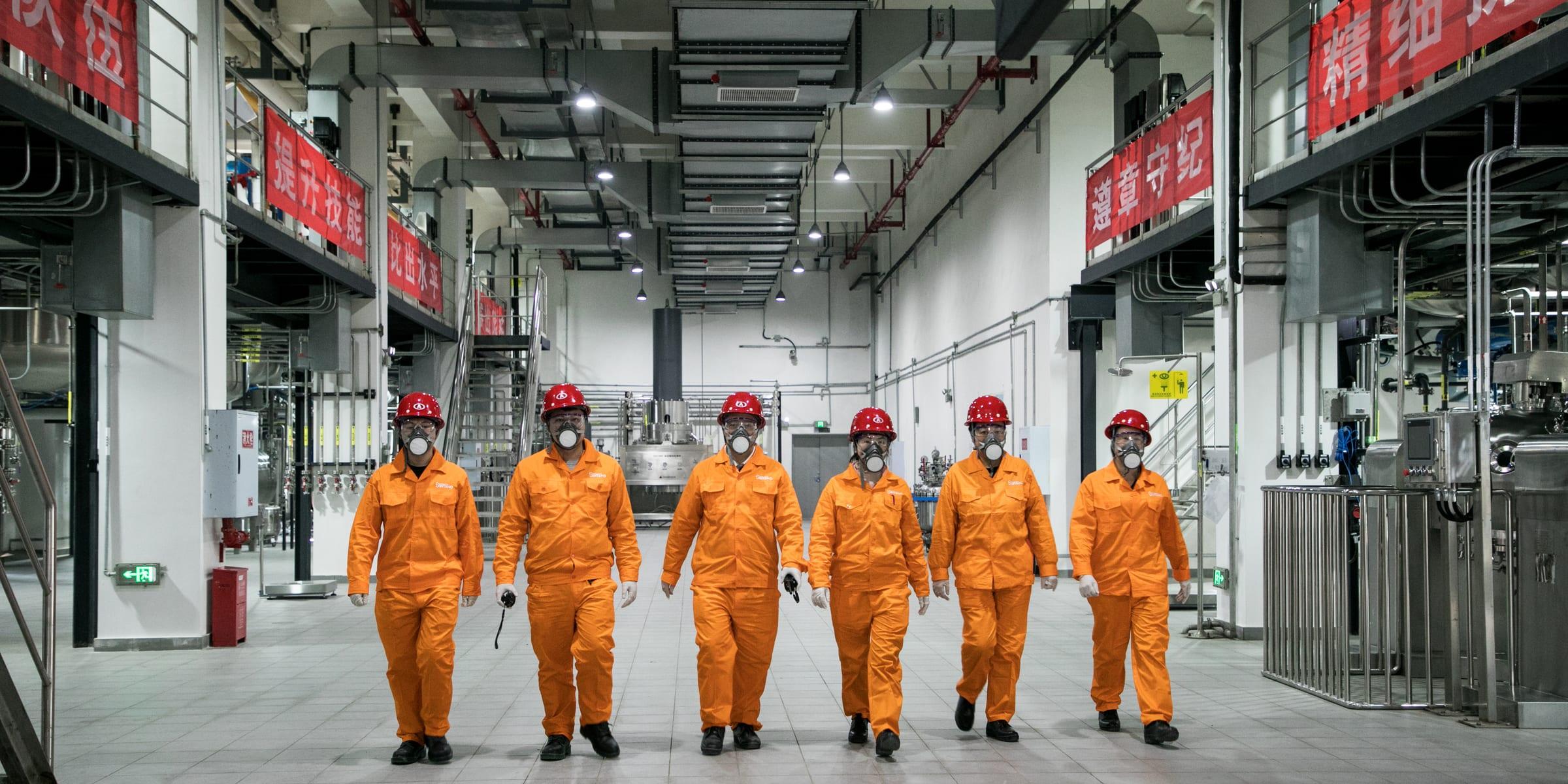 Operators walking through a partner manufacturing plant